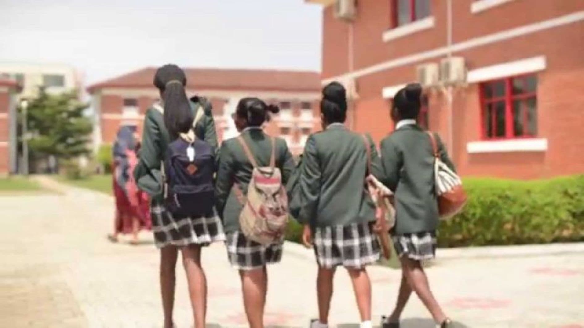 Secondary school students walking together on a school campus