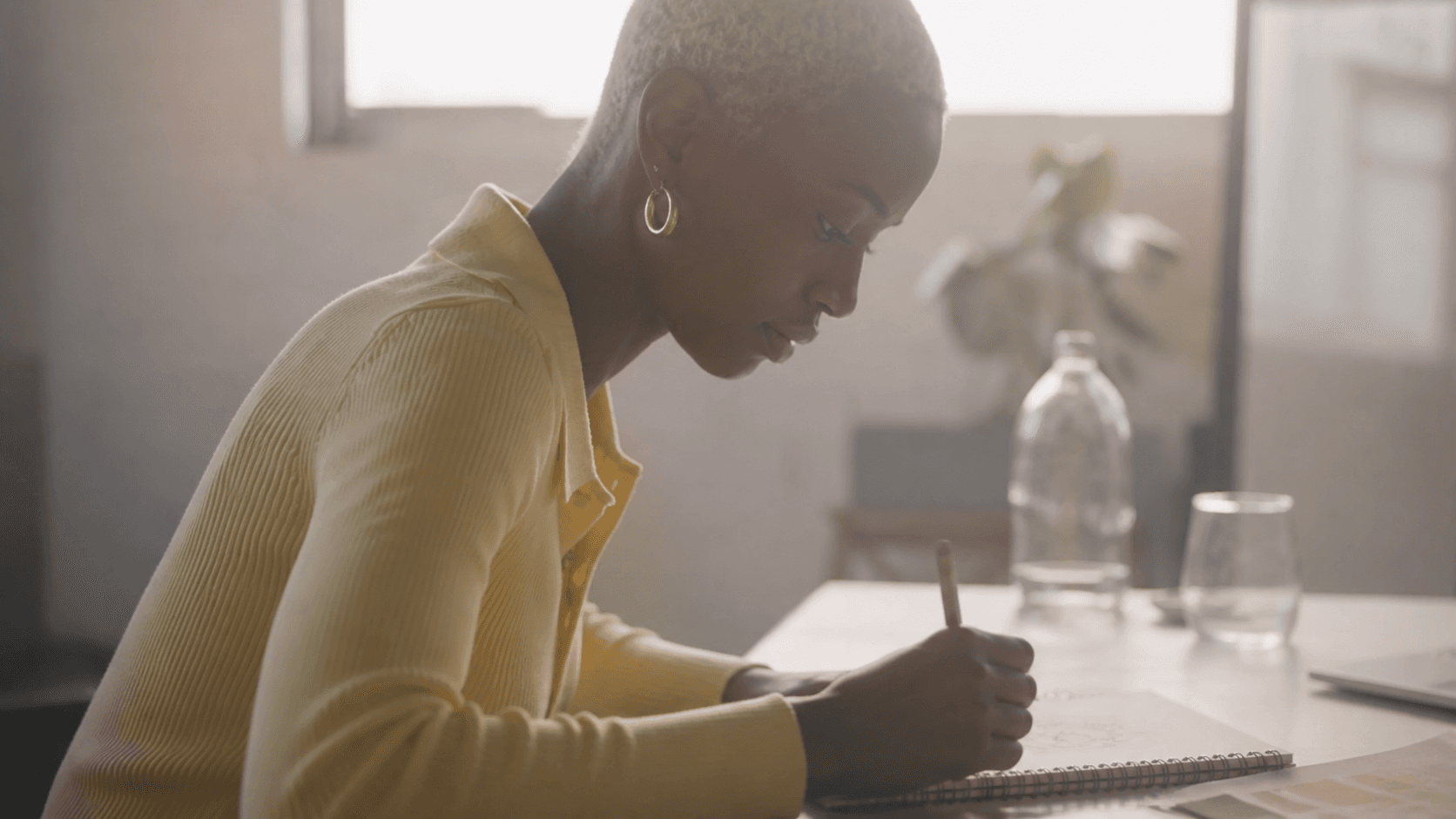 Black woman sketching brand ideas at a desk