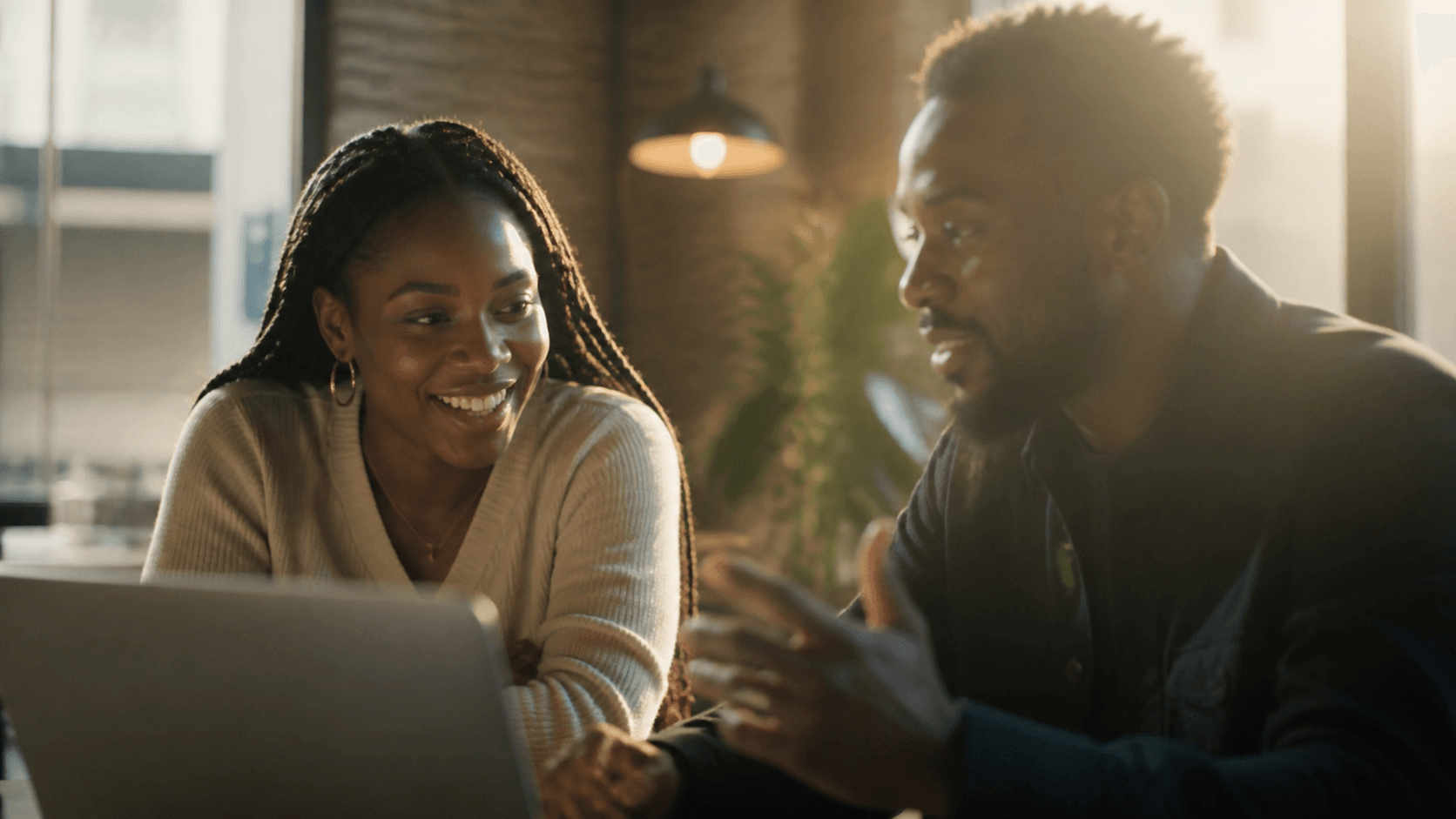 Two Black colleagues discussing a customer workflow