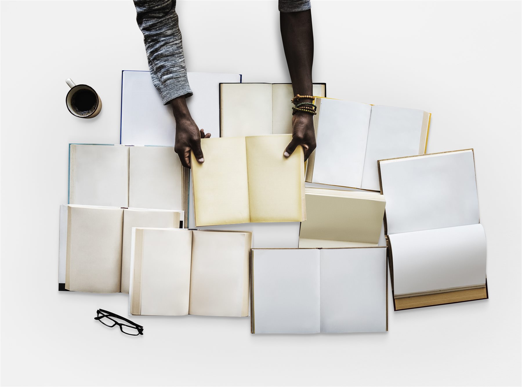 Open books arranged around a reader