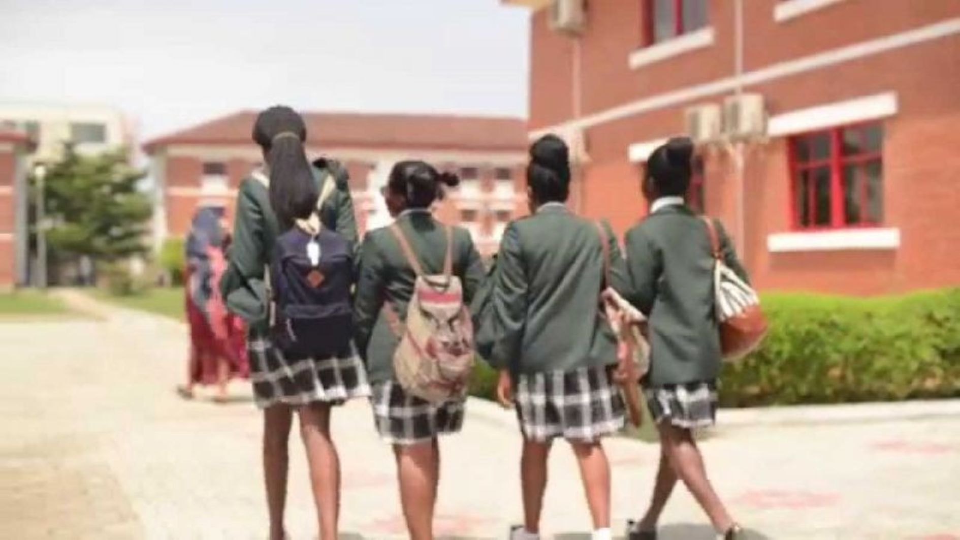 Secondary school students walking together on a school campus